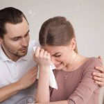 Husband comforting sad crying wife, man consoling sobbing young